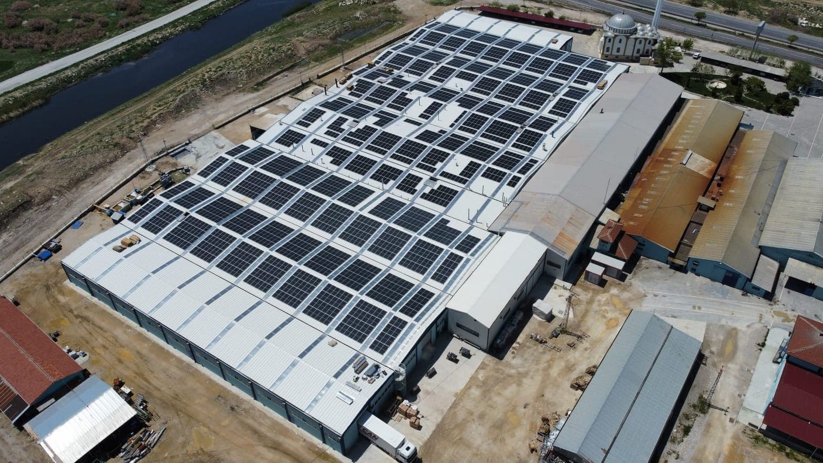 Aerial view of a factory roof covered in solar panels